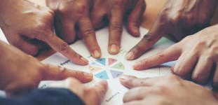 An image of fingers pointing to a diagram.